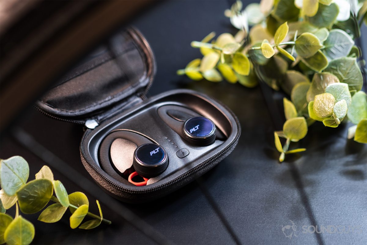 Plantronics_BackBeat-Fit-3100-2-1200x800 USB-C Headphones - Poly BackBeat Fit 3100: The earbuds in the case, which lays open, and flanked by two faux greenery pieces.