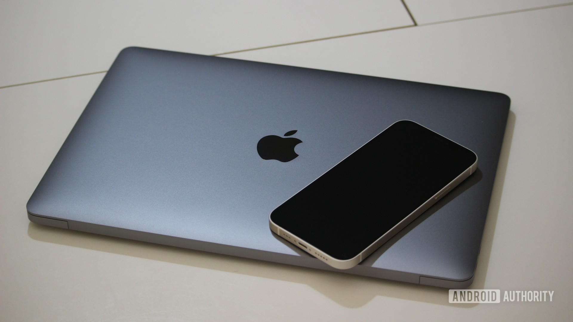 Apple MacBook Air M1 closed with iphone on top Apple MacBook Air M1 closed with iphone on top