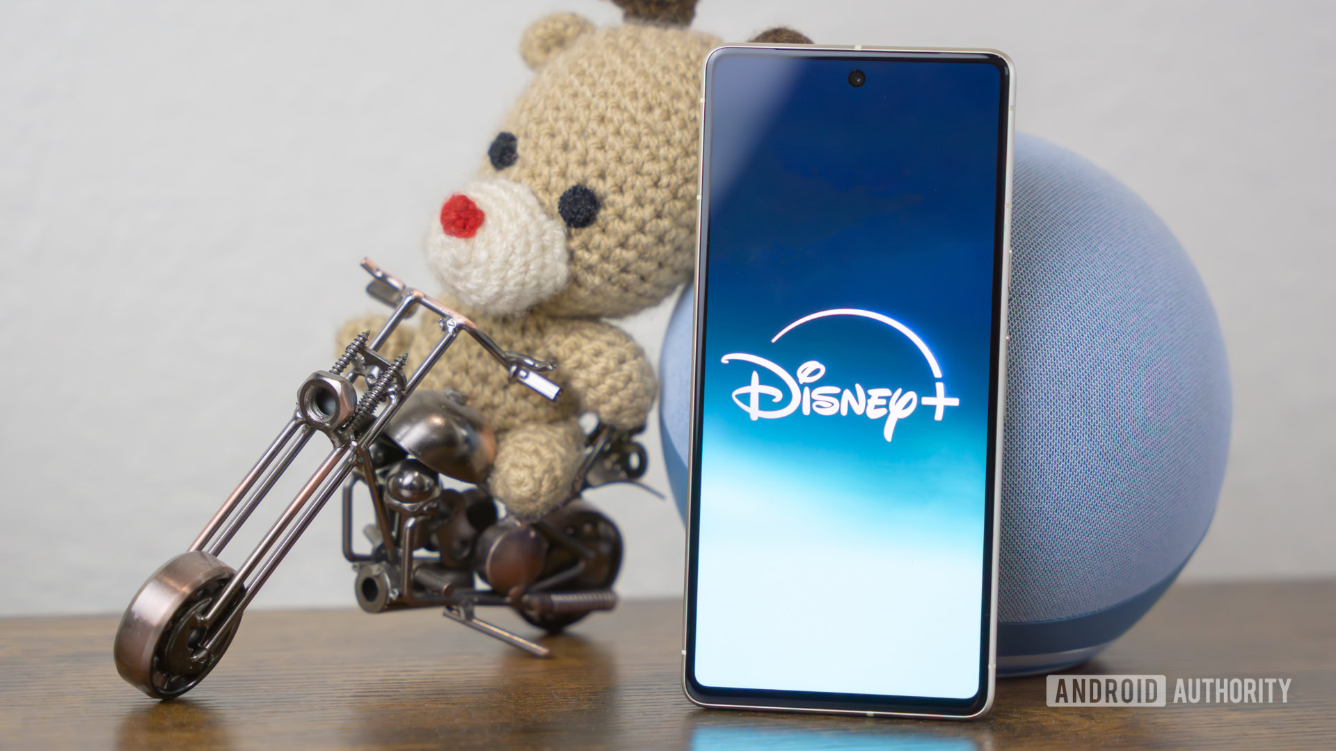 Disney Plus logo on smartphone laying on side table stock photo (3) Disney Plus logo on smartphone laying on side table stock photo (3)