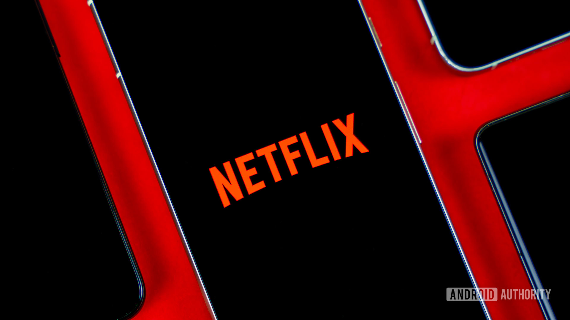 Netflix logo on smartphone, next to other devices stock photo (2) Netflix logo on smartphone, next to other devices stock photo (2)