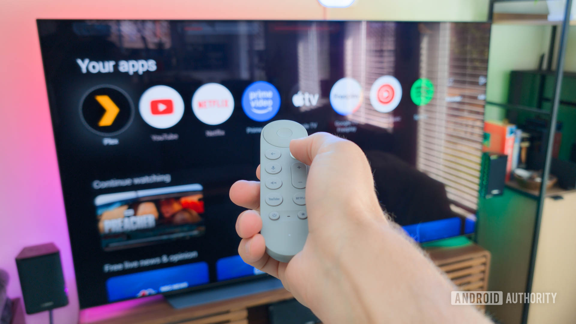 Google TV Streamer remote in hand controlling TV Google TV Streamer remote in hand controlling TV