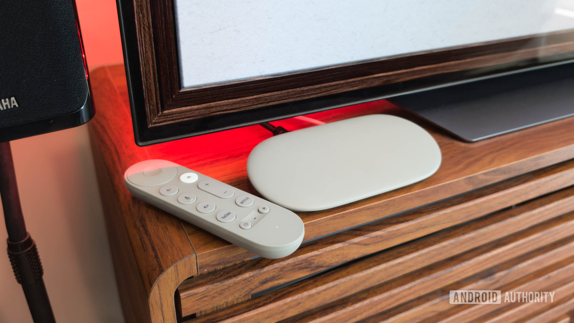 Google TV Streamer with Remote on TV console with red light Google TV Streamer with Remote on TV console with red light