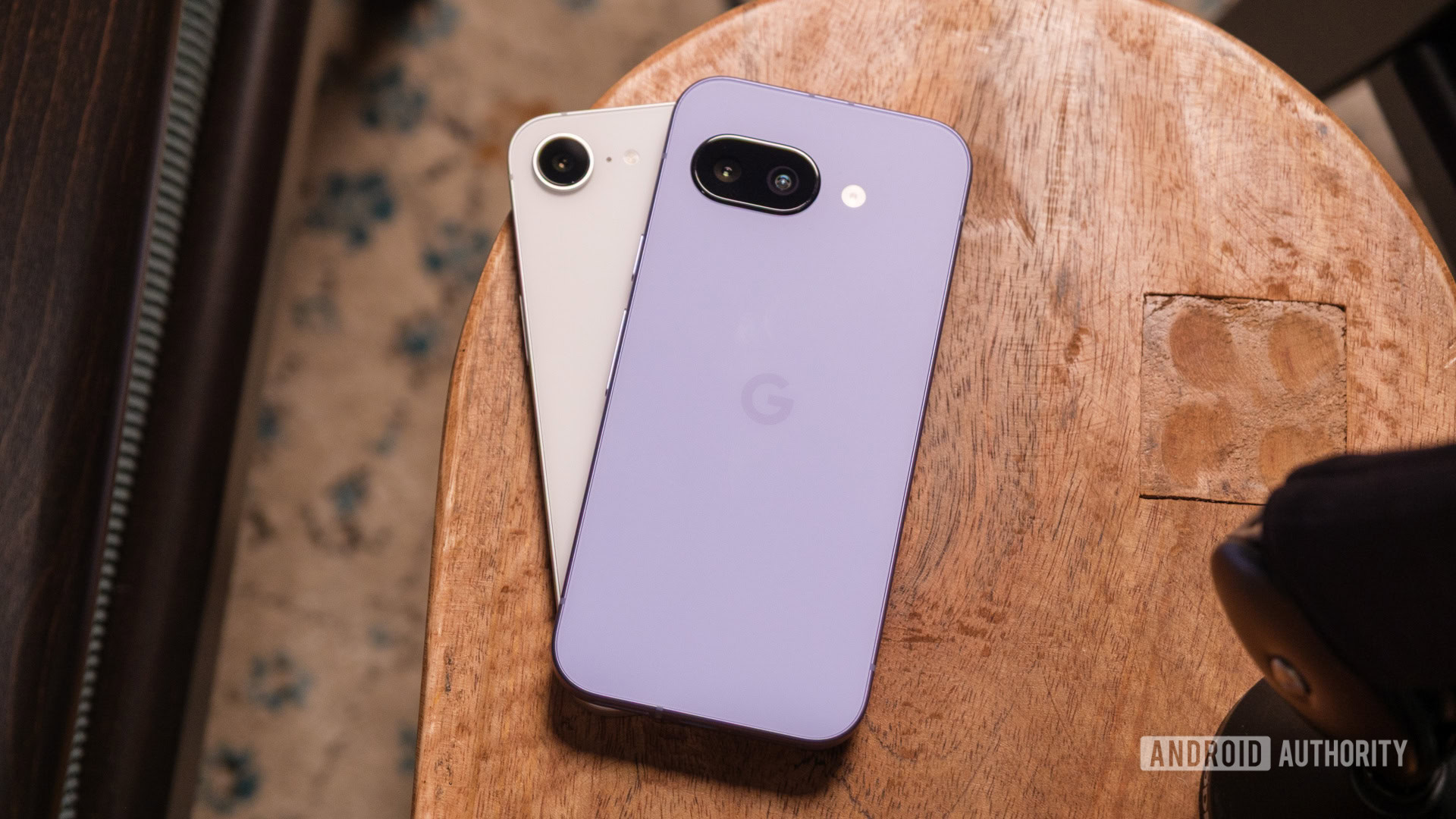 Google Pixel 9a vs iPhone 16e on table Google Pixel 9a vs iPhone 16e on table